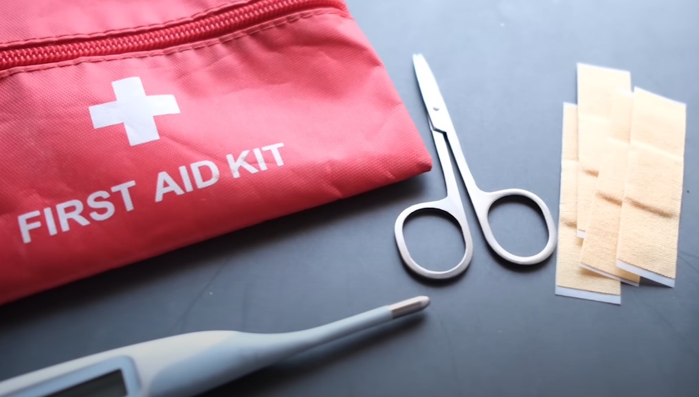 First aid kit and scissors in the first plan