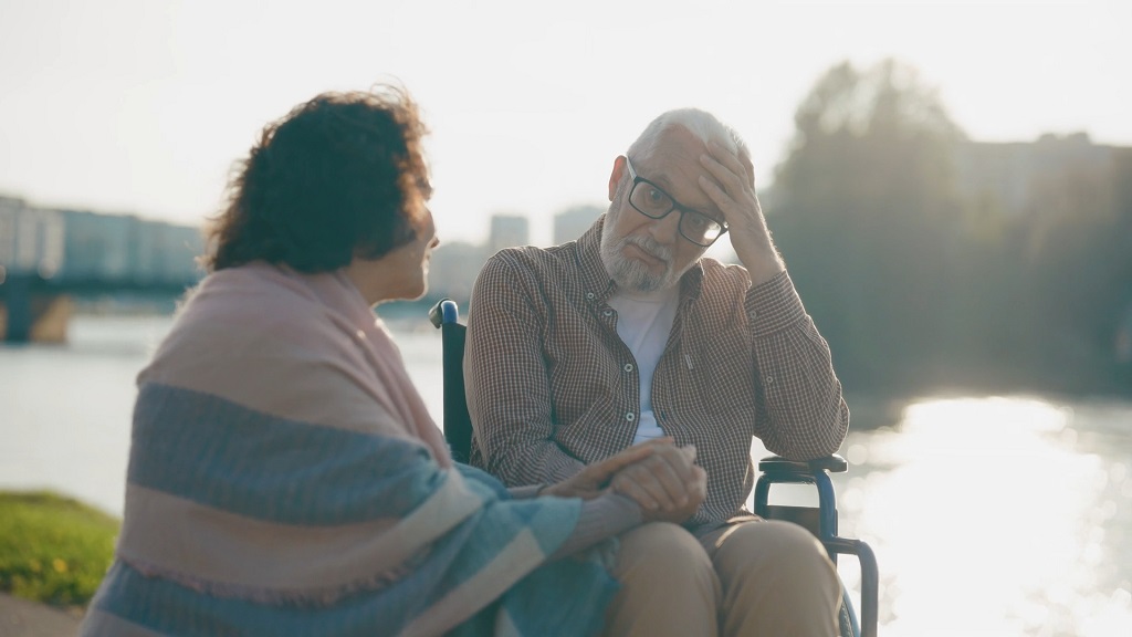 A private sitter assisting an elderly man during a walk